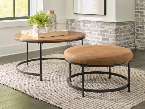 front view of the Caramel 2 Piece Table Set, a beige and black table and matching smaller, upholstered nesting table in a modern living room corner 