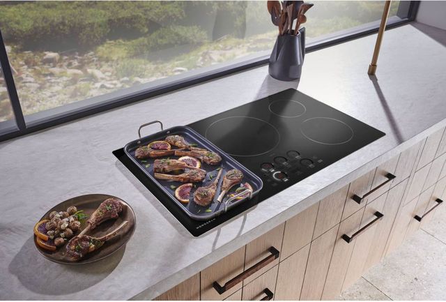 top view of lampchops cooking on a black monogram cooktop