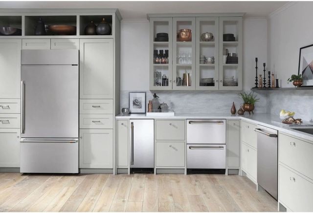 Built in bottom freezer refrigerator in a kitchen with other stainless steel appliances