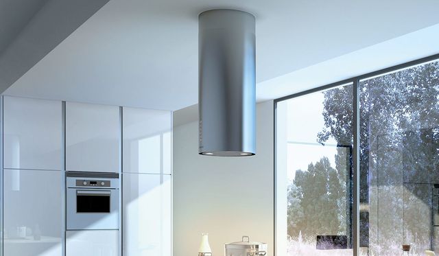 front view of the Faber Cylindra Isola 15" Stainless Steel Island Range Hood in a modern white kitchen