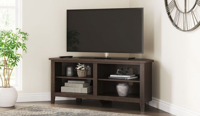 The Signature Design by Ashley Camiburg collection corner TV stand with decor 