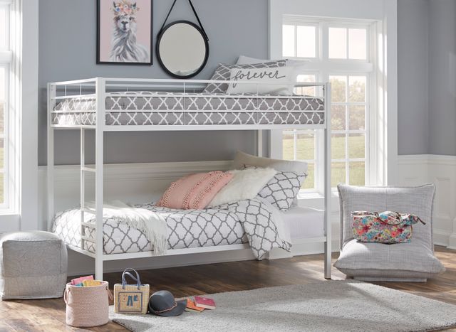 front left standing view of a light blue and grey kid's bedroom with pink accents and a white twin over twin metal bunk bed