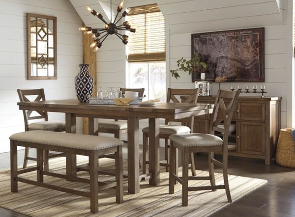 front view of a rustic dining room with matching table, chairs, bench, and sideboard