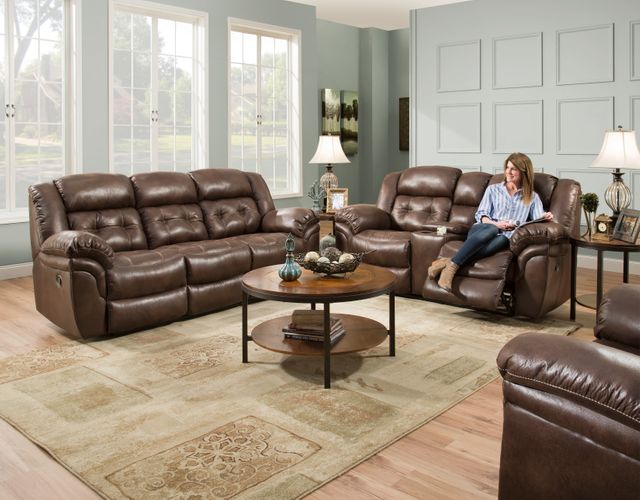 types-of-sofas front view of a modern transitional living room with a brown leather sofa and loveseat, a round wood coffee table, and a woman sitting and reclining in the loveseat