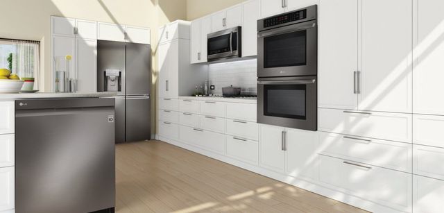 LG appliances are featured in a kitchen with white cabinets