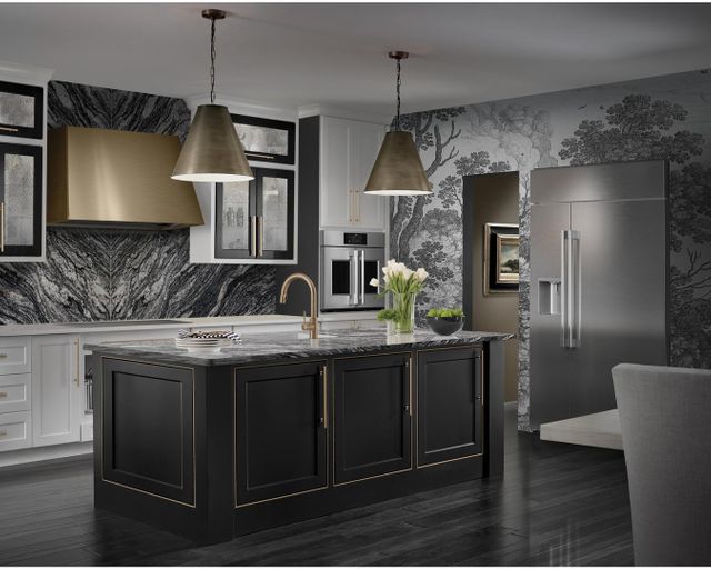 angled view of a modern luxurious kitchen with a black and white theme and a french door wall oven behind a kitchen island