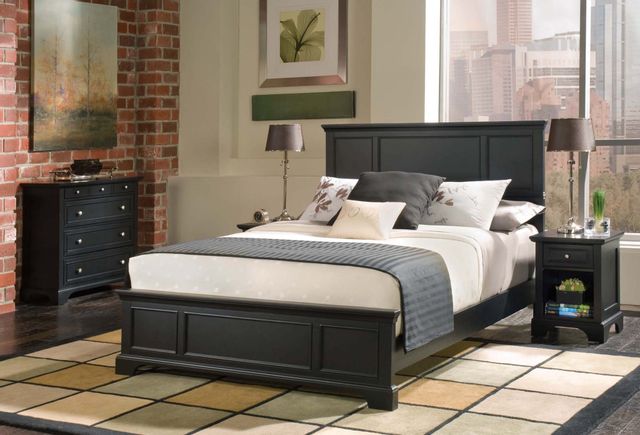 front view of a modern contemporary bedroom with matching black wood bed, dresser, and side table