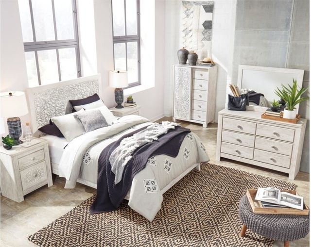 tall standing view of a modern white bedroom with matching glam white furniture, thoughtfully placed around the bedroom