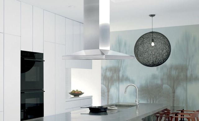 front view of an island range hood over an island in an all white modern kitchen
