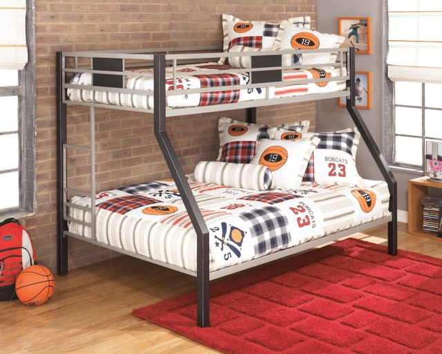 front view of a rustic style kids room with a beige painted metal twin over full bunk bed with sports themed sheets and pillows