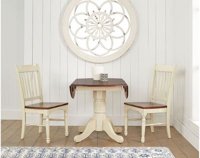 round wood pedestal dining table and chairs in a white dining nook