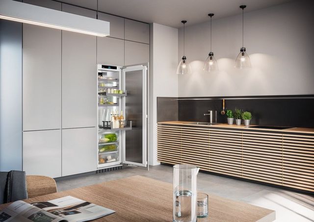 front view of a modern luxury kitchen with a panel-ready column refrigerator opened