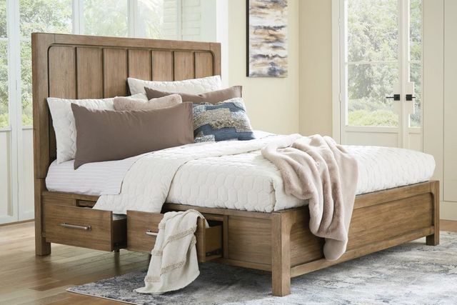 front view of a wooden storage bed with two drawers pulled out showing blankets inside