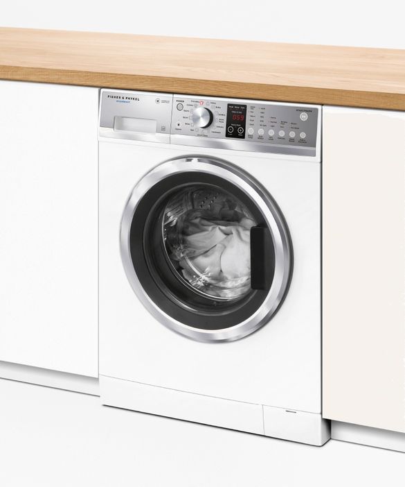 White Fisher & Paykel washing machine in a laundry room