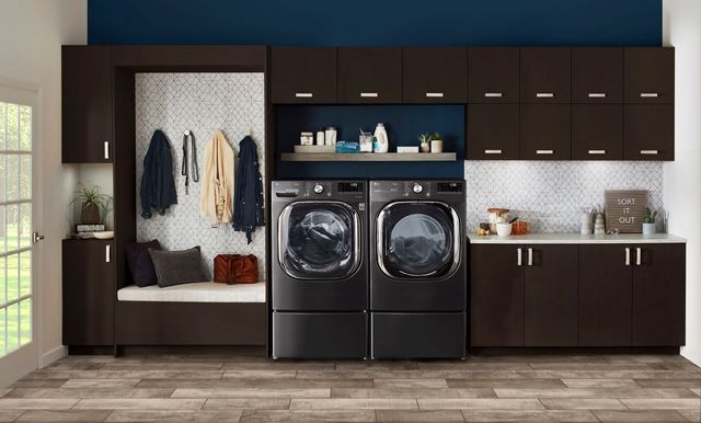 LG black steel front load washer and dryer in a brightly lit laundry room