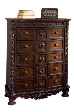 front view of a traditional wooden chest with 5 drawers and ornate wooden details
