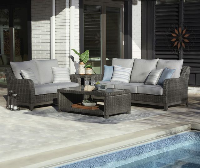 view of an outdoor sofa, matching chair, matching coffee table next to a pool in front of the back of a home