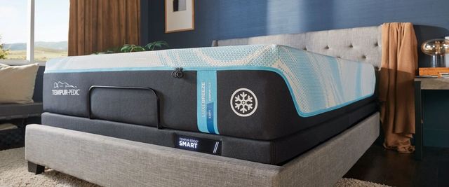 front right view of a tempur-pedic luxe-breeze mattress on a light grey bed frame