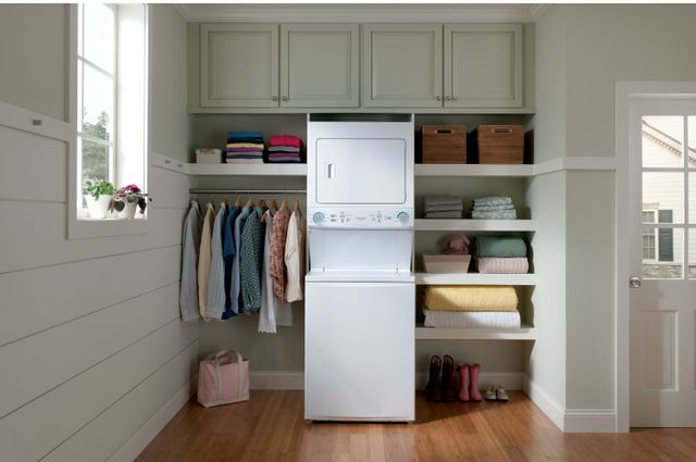 Stacked washer dryer unit in a traditional laundry room