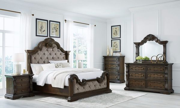 Bedroom Showcasing a Signature Design by Ashley Maylee Dark Brown Upholstered Queen Panel Bed