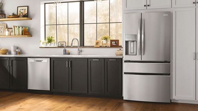 front view of a modern kitchen with a stainless steel french door refrigertor 