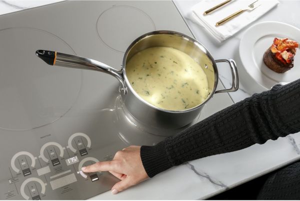 Kitchen Featuring a Monogram 30" Silver Induction Cooktop