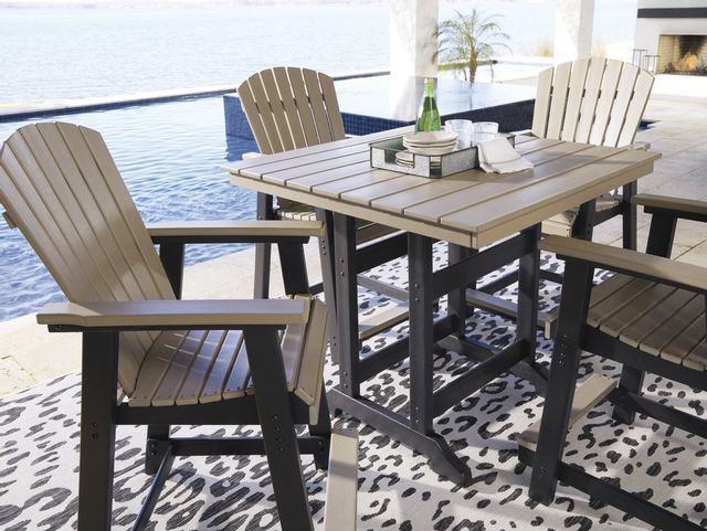front view of a plastic square dining table with a body of water in the background