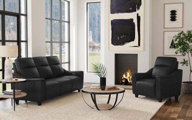 front view of a modern black and white living room with a black sofa and power recliner