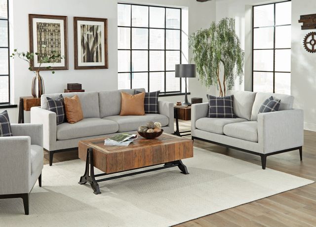 front view of a rustic mid-century living room with decor throughout incluging a lamp, bowl, plants, and miscellaneous decor