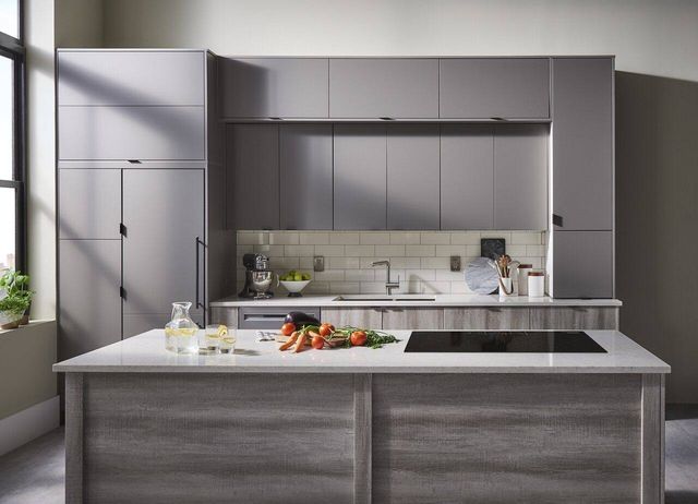 Austere grey kitchen with black induction cooktop built into counter