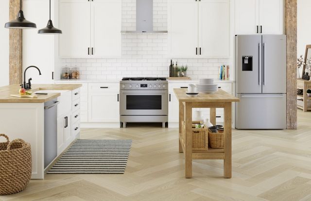 front view of a modern kitchen with white walls, stainless steel bosch appliances