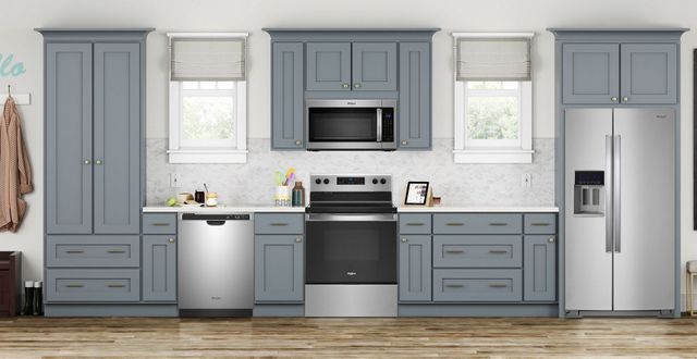 front view of a modern kitchen with light blue cabinets and stainless steel appliances throughout