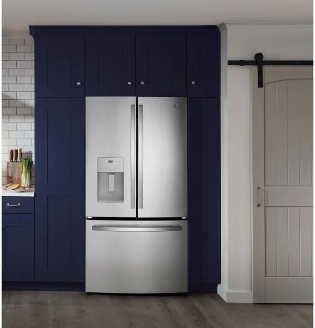 A GE French door refrigerator in a kitchen with dark blue cabinets