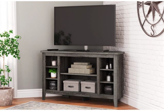 The Signature Design by Ashley Arlenbry corner TV stand with decor 