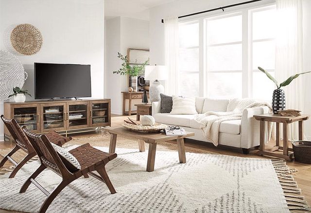 front view of a modern boho living room with a wood tv console with glass doors