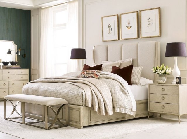 front view of a modern bedroom with cream furniture and an upholstered bed frame