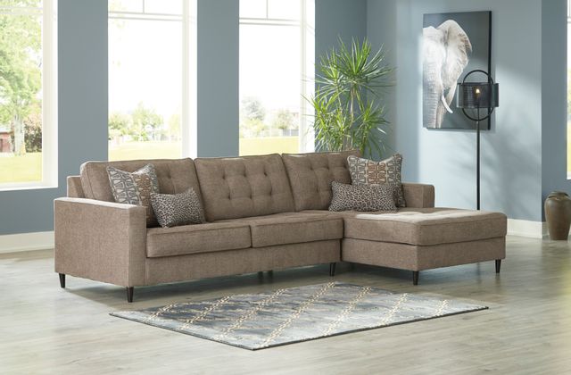 front view of a living room with light blue walls and a beige chaise sofa
