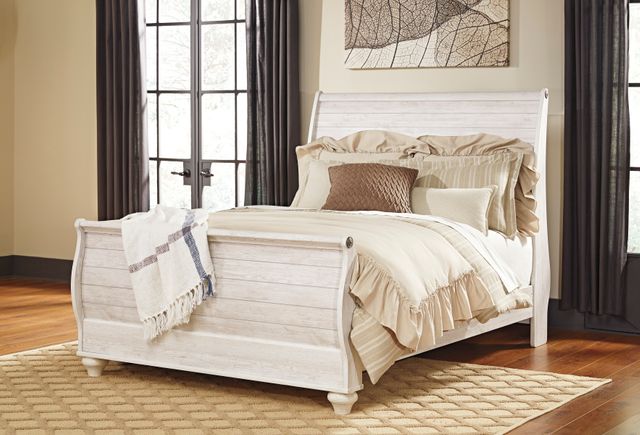 Distressed white coastal style sleigh bed in a bedroom