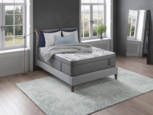 view of a full size mattress in a modern bedroom with large windows and a mirror