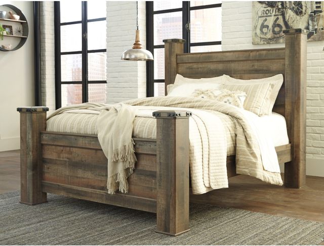 front right view of a wooden poster bed in a rustic beige bedroom