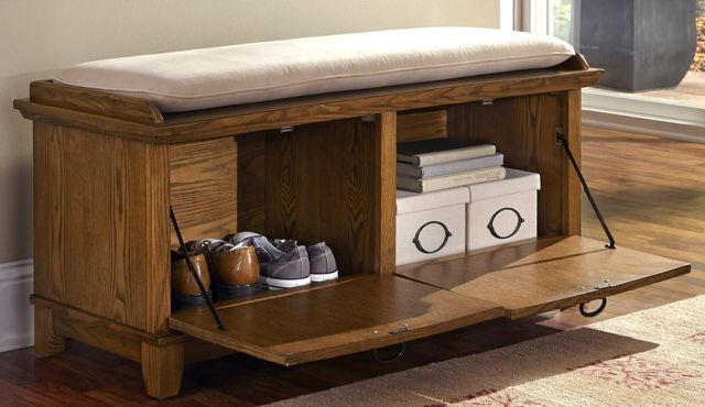 front view of an opened wooden storage bench with shoes and boxes inside