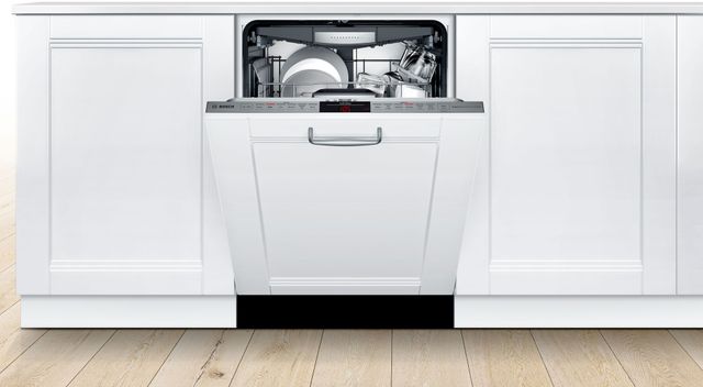 front view of a bosch white panel ready dishwasher slightly opened in a white cabinet