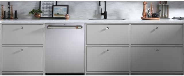 front view of a stainless steel cafe dishwasher built into light grey cabinetry