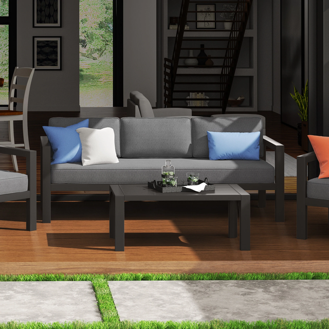 front view of a black and grey outdoor sofa with matching chair and coffee table in a contemporary space