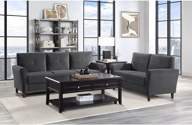 front view of a modern living room with black furniture, white walls, and large windows