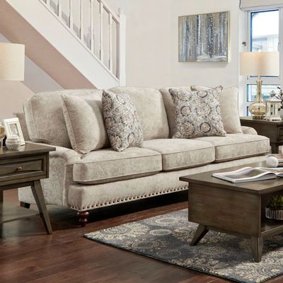 front view of the Margo Sofa, a transitional cream stationary sofa with brass and wood accents