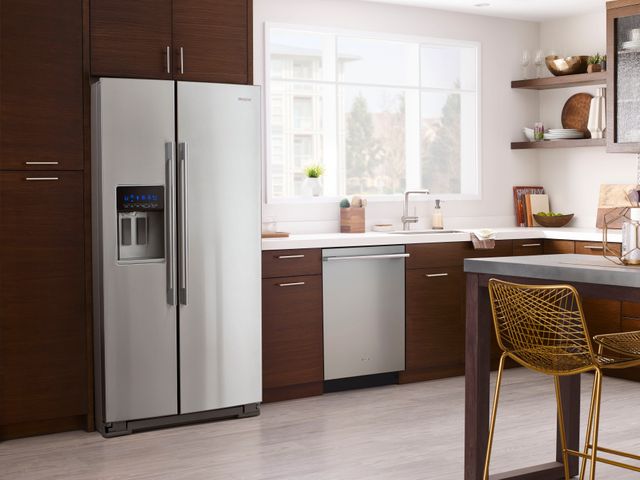 front view of a modern kitchen with a counter depth refrigerator in brown cabients