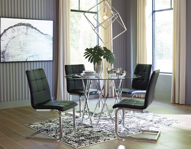 front view of a contemporary dining room with a round glass table and black leather chairs around it