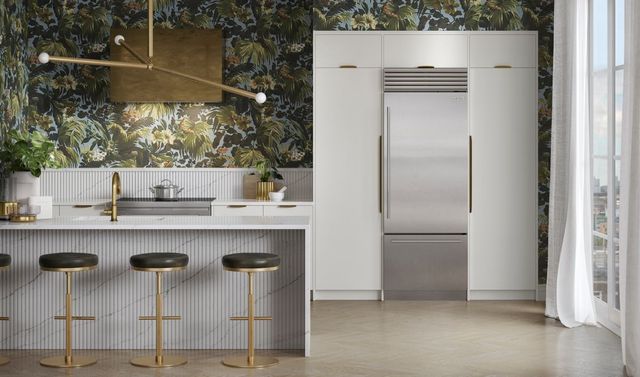 stainless steel built in bottom freezer refrigerator in a modern luxury kitchen