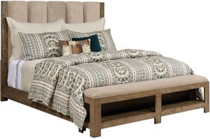 view of the American Drew® Meadowood Oak King Upholstered Panel Bed with a beige boho style comforter and matching pillows